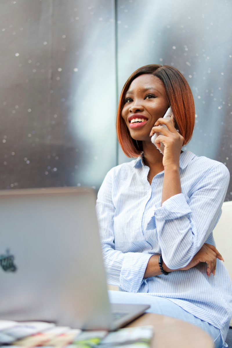 Female customer service representative on the phone and laptop, demonstrating outsourced customer service solutions in action.