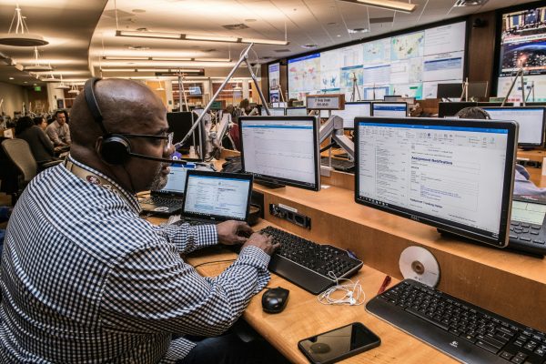 Man taking calls at his workstation demonstrating call center automation strategies.