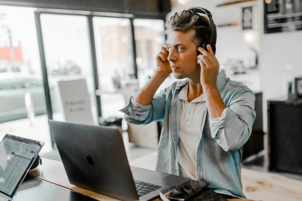 Man wearing a headset taking calls as part of scaling customer service for growing businesses.