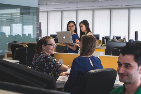 Office workspace of top call center companies with agents at headsets and organized workstations.