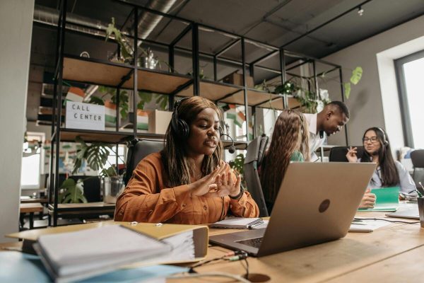 Customer service agents taking calls providing multilingual customer service outsourcing.