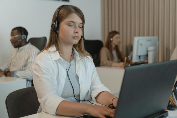 Customer support representative wearing a headset offering reliable call center services.