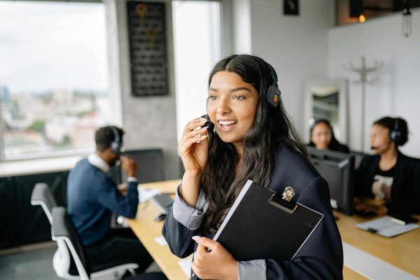 Customer service agent taking calls, demonstrating automation in customer service to improve efficiency and response time.
