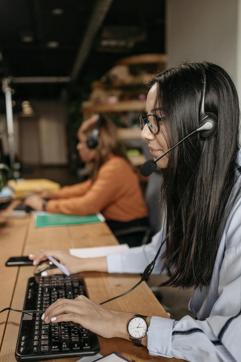 Call center agent highlighting outsourcing customer support benefits