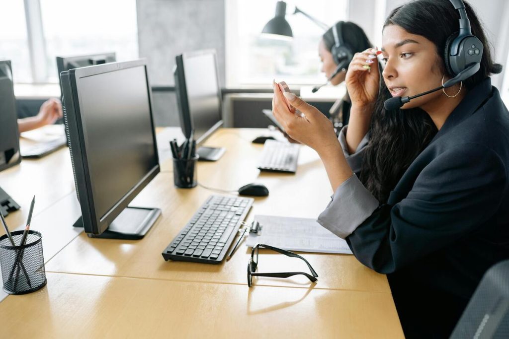 Call center agent delivering hospitality outsourcing services on a support call