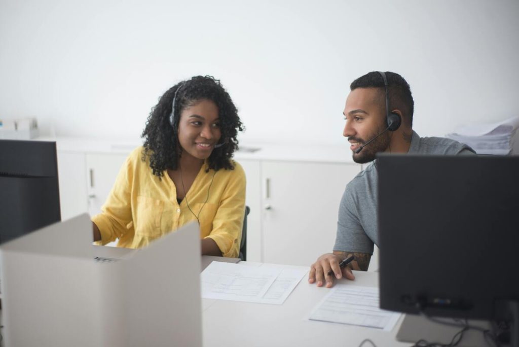 Call center agents handling customer calls using contact center workforce management solutions