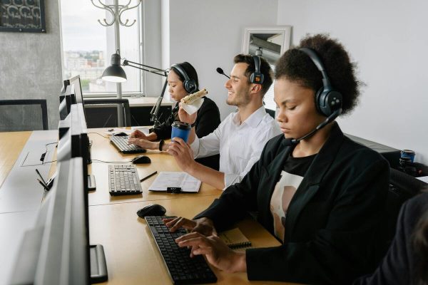 Customer service agents handling calls in a support center, showing BPO for IT services