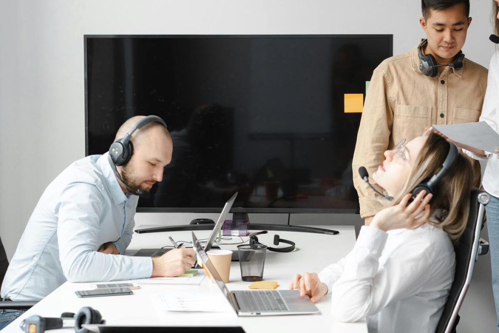 Customer service agents taking calls in a modern office with agent performance monitoring