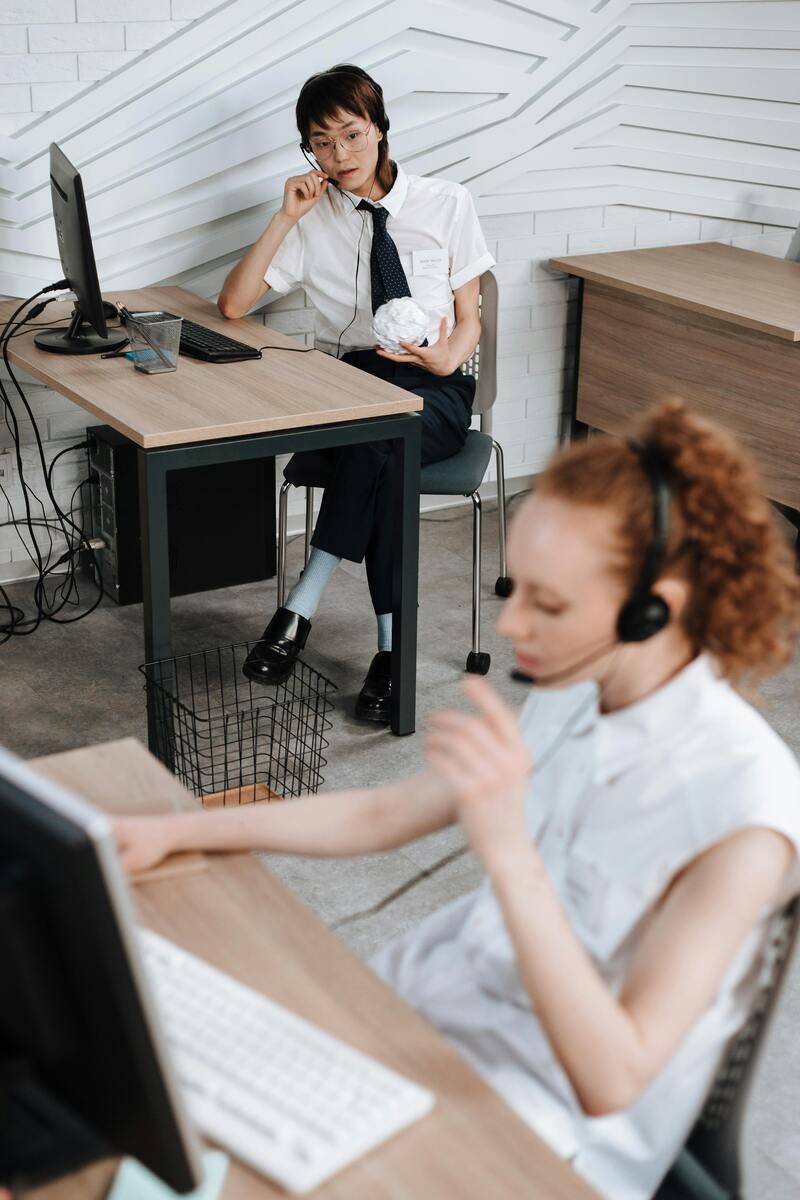 Customer service agents taking calls supported by AI workforce management for contact centers