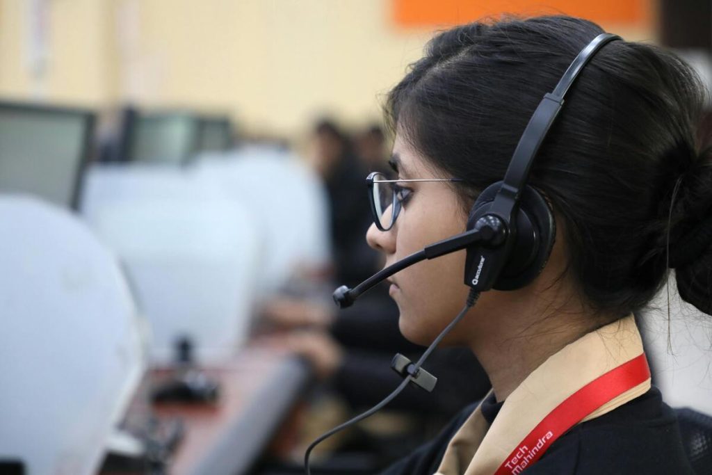 Call center agent assisting customers for SaaS customer support outsourcing services
