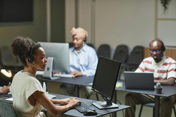 Call center staff managing support calls in office