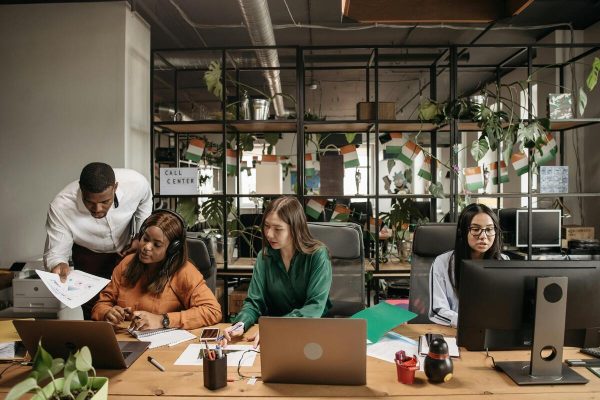 Customer service agents collaborating in an office for outsourced ecommerce support