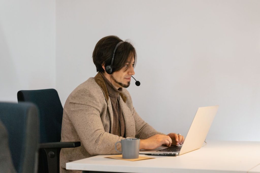 Call center agent offering best call center services with wearing headset with laptop