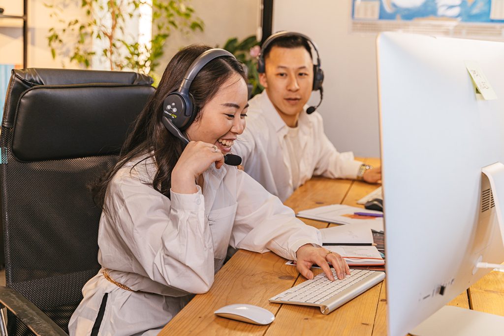 Call center agents providing customer service BPO support while with office colleague