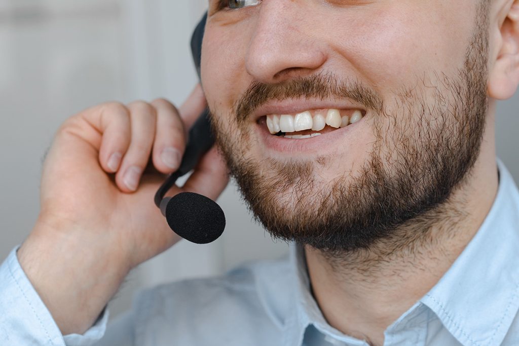 Customer support for startups specialist handling customer calls with smiling face