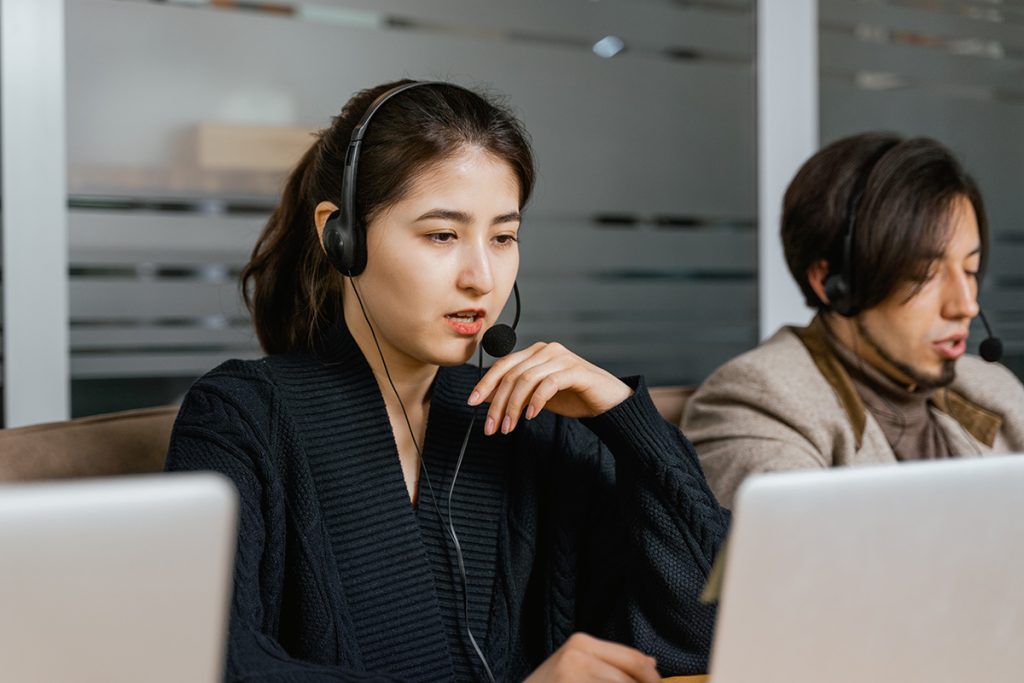 Customer support representatives providing assistance and resolving customer inquiries in a modern call center