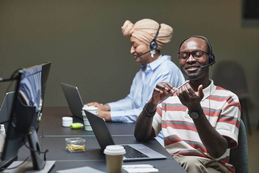 SaaS customer support agents wearing headsets handling customer calls and providing professional technical assistance.