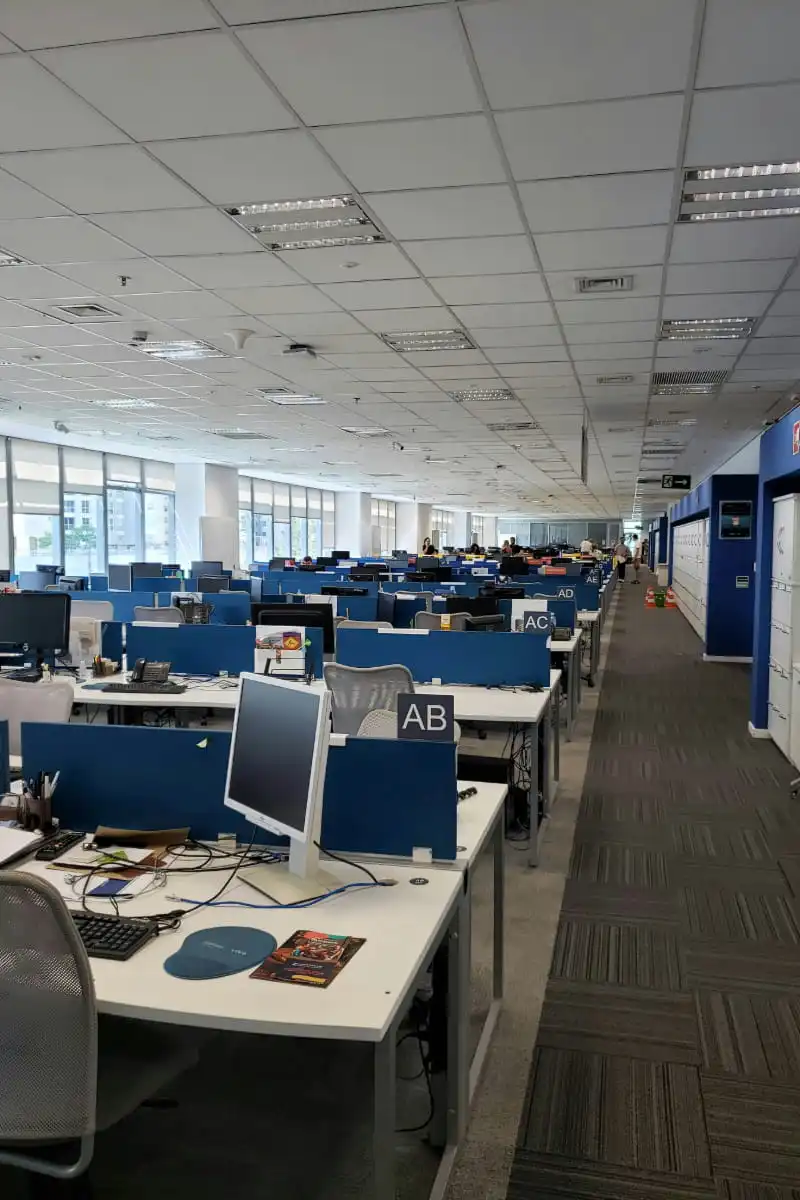 Call center office with desks and computers for global customer support outsourcing.