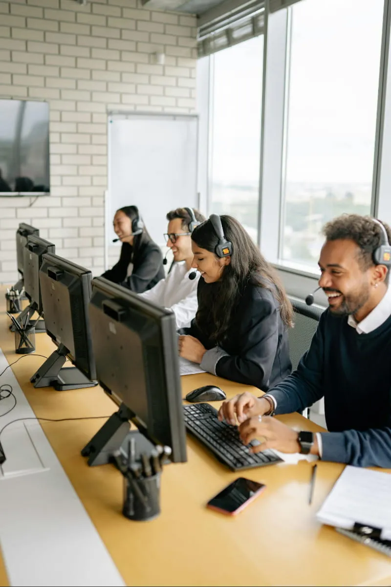 Call center team collaborating, showcasing customer support outsourcing benefits for businesses.