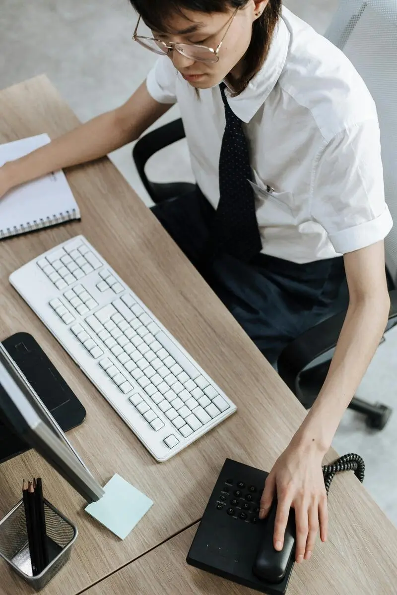 Customer service agent in an office providing omnichannel customer support across phone, chat, and email channels.