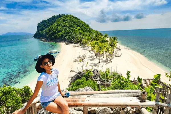 Tourist enjoying panoramic views of a tropical island and sandbar